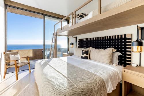 a bedroom with a large bed and a large window at Private Hot Tub - Ocean View - GYM - Free Parking in San José del Cabo