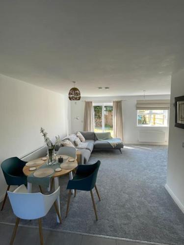 a living room with a couch and a table and chairs at Cashel on the Coast, 3 bedroom holiday home, Ballycastle in Ballycastle