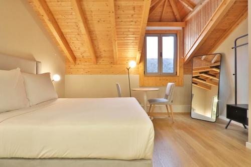 a bedroom with a bed and a table and a staircase at BOULEVARD Boutique Studios in Lisbon