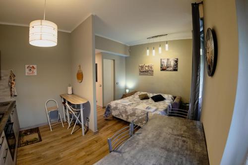 a room with a bed and a table in it at La maison di Roberto in La Spezia