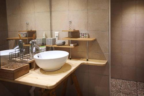 a bathroom with a white bowl sink on a counter at Duplex dans village avec jardin in Claix