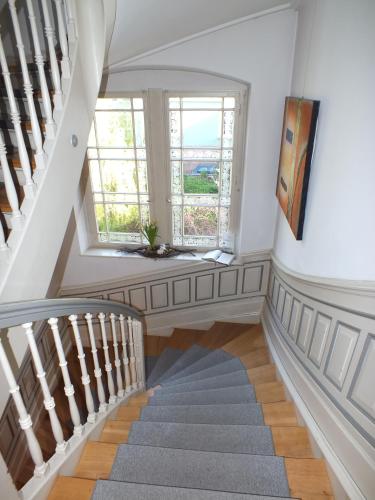 a staircase in a house with a window at Alleehaus in Freiburg im Breisgau