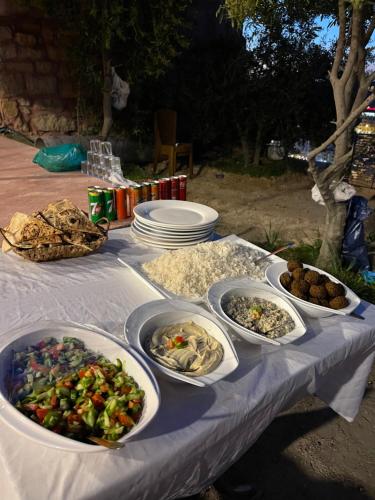 a table with several dishes of food on it at RoadHouse - Petra in Wadi Musa