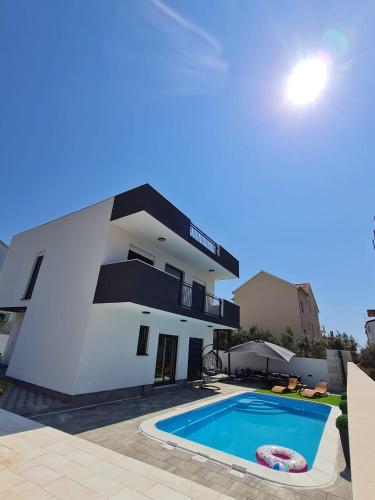a view of a villa with a swimming pool at LuxVilla AURORA in Vodice