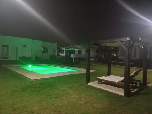 a swimming pool in a yard at night at ADVENTURE House in Nancito