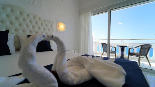 two towels are laying on a bed in a bedroom at Valtos View in Parga