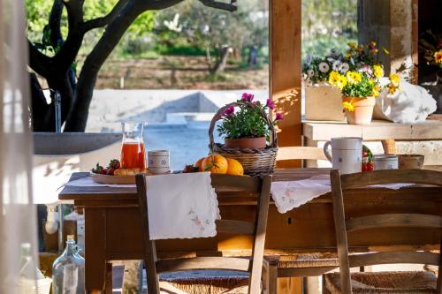 a table with a plate of fruit and juice on it at B&B Dimora Castello in Galatone