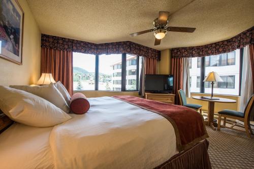 a hotel room with a large bed and a window at The Grand Lodge Hotel and Suites in Mount Crested Butte