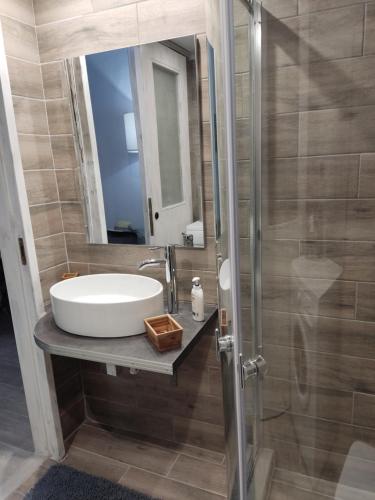 a bathroom with a sink and a mirror at ISMINI STUDIOS in Menídion