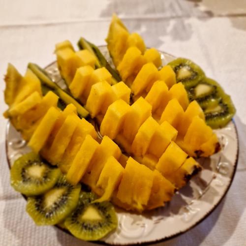 a plate of fruit and vegetables on a table at B&B Santa Brigida in Santa Brigida