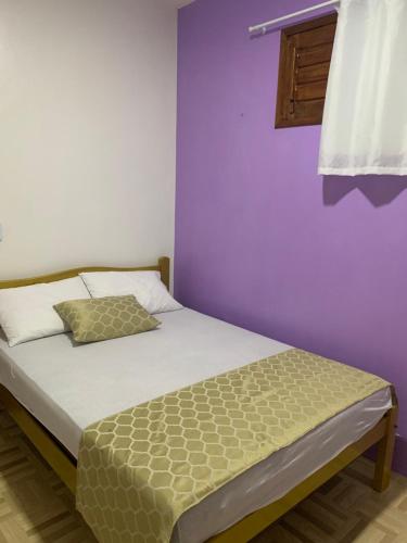 Una cama o camas en una habitación de Happy Hostel e Pousada Paracuru