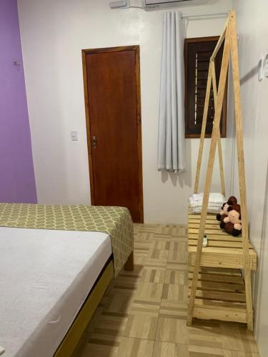 Una cama o camas en una habitación de Happy Hostel e Pousada Paracuru