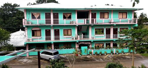 a blue building with a car parked in front of it at LEHNS MOTEL in Koror