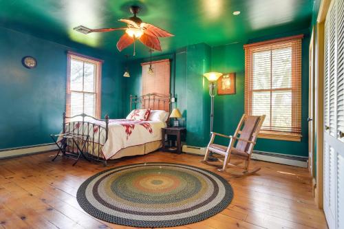 a bedroom with green walls and a bed and a rug at Rustic Wellsville Home - 5 Mi to Roundtop Mountain 