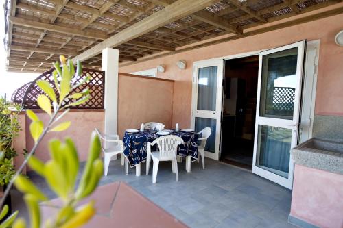 a patio with a table and chairs on a balcony at Le Dune in Follonica