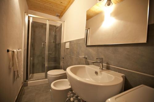 a bathroom with a sink and a shower and toilet at Le Dune in Follonica