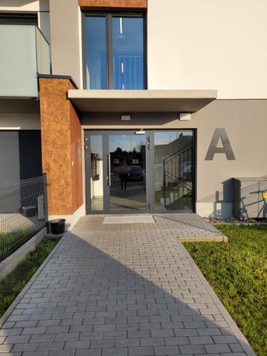 an entrance to a building with an a sign on it at Apartament Korczaka 6 in Śrem