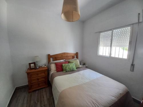 - une petite chambre avec un lit et une fenêtre dans l'établissement Chalet Chiclana, à Chiclana de la Frontera