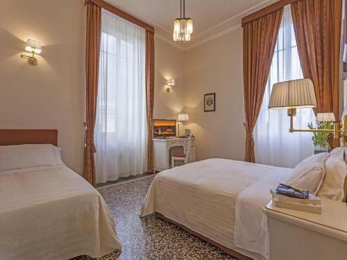 Ένα ή περισσότερα κρεβάτια σε δωμάτιο στο Hotel Astro Mediceo
