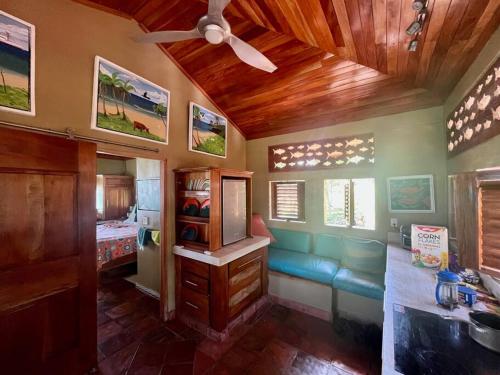 a room with a couch and a ceiling fan at 'Crows Nest' Studio Apt. in Big Corn Island