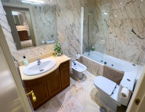 a bathroom with a sink and a toilet and a tub at Dream Apartment in Mijas Golf Limonar in Mijas Costa