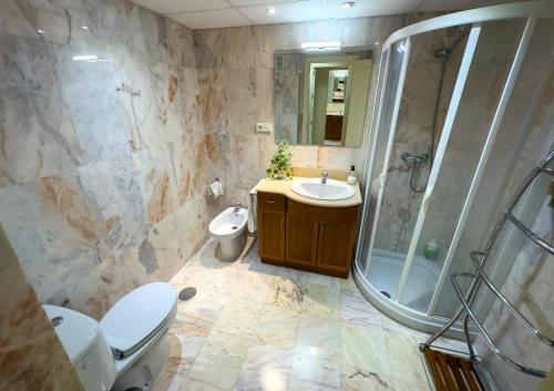 a bathroom with a toilet and a sink and a shower at Dream Apartment in Mijas Golf Limonar in Mijas Costa