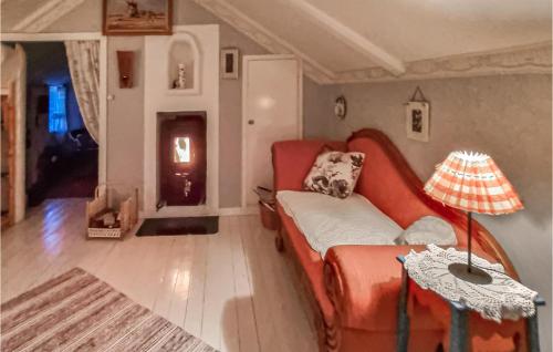 - un salon avec un canapé rouge et une table dans l'établissement Gorgeous Home In Mrbylnga, With Kitchen, à Mörbylånga