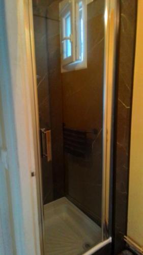 a shower with a glass door in a bathroom at Franglais Flats in Boulogne-sur-Mer