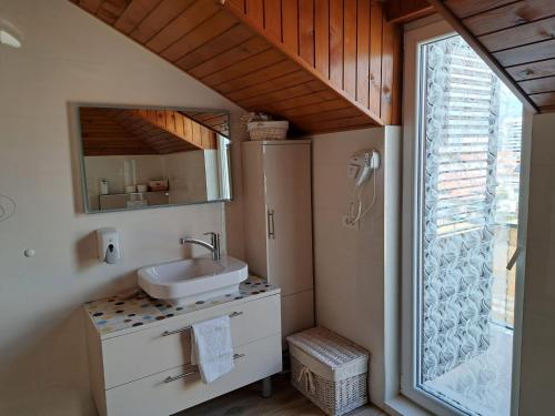 a bathroom with a sink and a mirror at Apartment Bella Sanja in Split