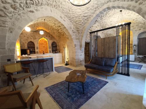 a living room with a couch and a table at TUĞMANER Small House AJAR in Mardin