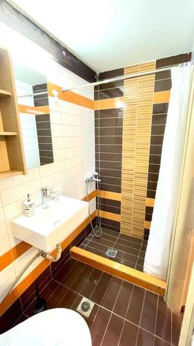 a bathroom with a sink and a shower and a toilet at Elegant modern loft in Kryopigi in Kriopigi