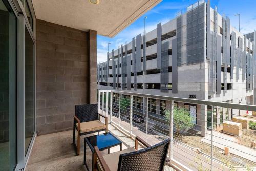 a balcony with a table and chairs and a building at Tempe Lofts in Tempe
