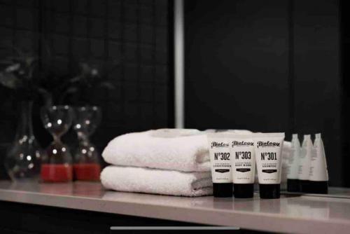 a pile of towels on a counter in a bathroom at 1Br Braddon retreat with mountain views in Canberra