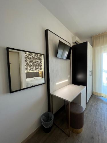 a room with a table and a mirror on a wall at Villa Liliana in Cervia