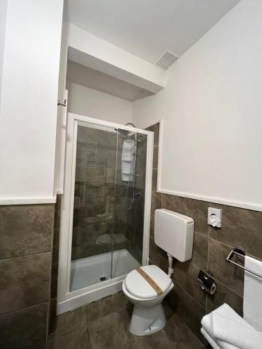 a bathroom with a toilet and a shower at Villa Liliana in Cervia