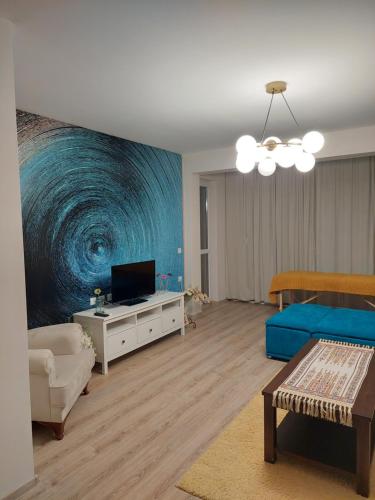 a living room with a large painting on the wall at Sandanski Apartments Top Center in Sandanski