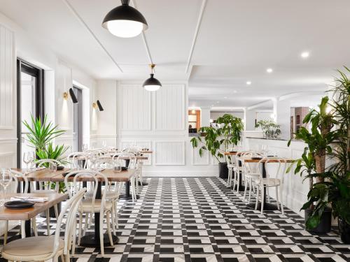 a restaurant with tables and chairs on a black and white checkered floor at The Metcalfe by Gray Collection in Ottawa