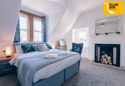 a bedroom with a bed and a fireplace at Private Courtyard Cottage - Parking - WiFi in Dundee
