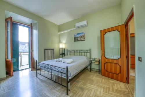a bedroom with a bed and a large window at Pellicciari 14 - Affitti Brevi Italia in Gravina in Puglia