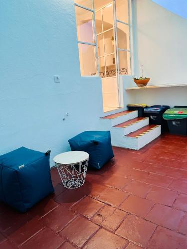 a patio with a basketball hoop and blue wall at Casa da Salúquia in Moura