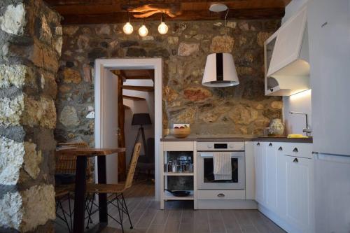 a kitchen with a stove and a staircase in it at Hemeros Villa in Zefiría