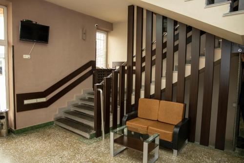 a stairway with a chair and a tv on a wall at ASA Hotel in Yerevan