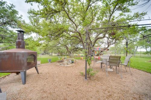 a backyard with a grill and a table and chairs at Secluded Country Hideaway with Fire Pit and Pool! in Blanco