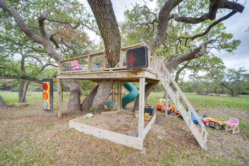 a tree house with a playground in a tree at Secluded Country Hideaway with Fire Pit and Pool! in Blanco