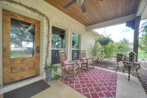 a porch with rocking chairs and a wooden door at Secluded Country Hideaway with Fire Pit and Pool! in Blanco