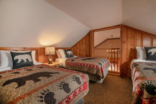 a hotel room with two beds and a balcony at Christmas Farm Inn and Spa in Jackson