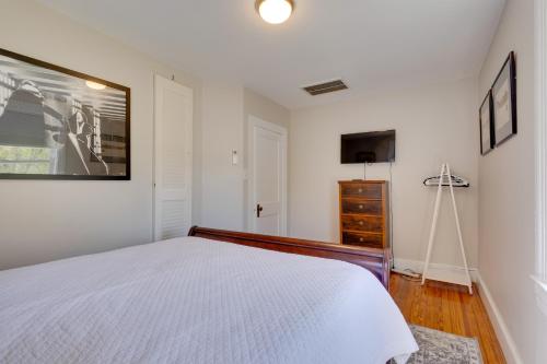 a white bedroom with a bed and a dresser at Beautiful Colonial Home on the Choptank River in Cambridge