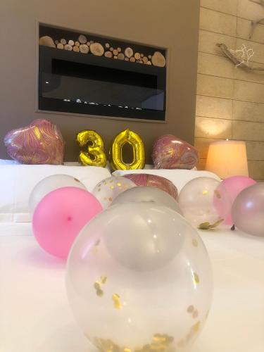 a bunch of balloons sitting on top of a table at ZEROstuni suite apartment in Ostuni