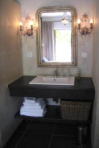 a bathroom with a sink and a mirror at "Le Vent d'Étoile" B&B and Guesthouses in Mormoiron