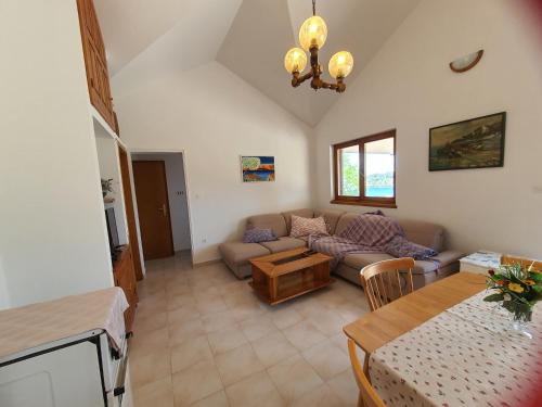 a living room with a couch and a table at Mendula Apartment in Rogač